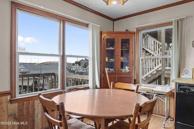 241 Moonlight Dr, Atlantic Beach, NC 28512 - dining space featuring light wood finished floors, ornamental molding, and stairs