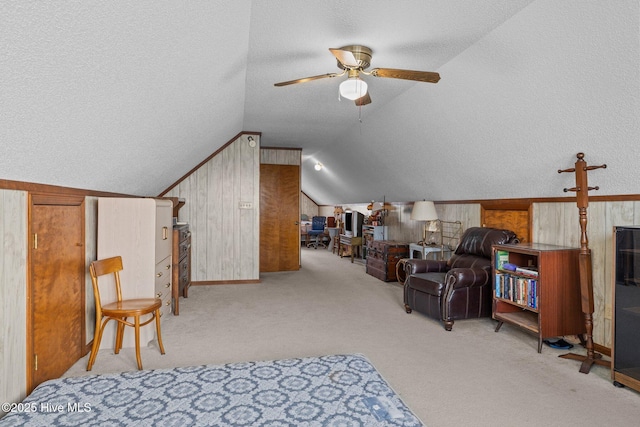 241 Moonlight Dr, Atlantic Beach, NC 28512 - bedroom with vaulted ceiling, a textured ceiling, carpet, and wood walls