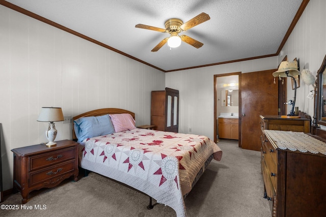 241 Moonlight Dr, Atlantic Beach, NC 28512 - bedroom featuring light carpet, ornamental molding, ensuite bathroom, a ceiling fan, and a textured ceiling