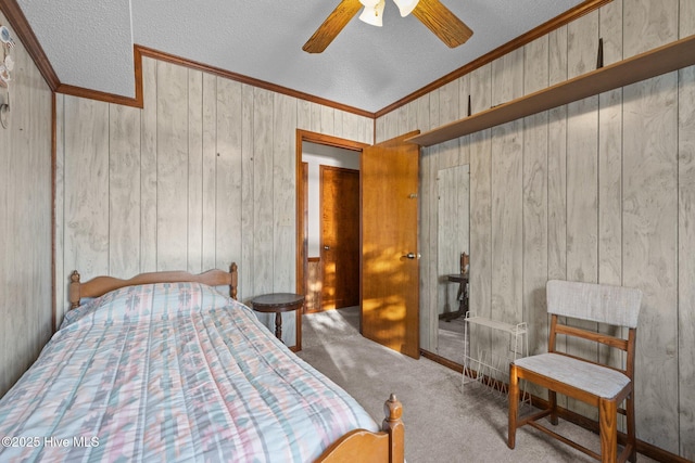 241 Moonlight Dr, Atlantic Beach, NC 28512 - bedroom with a textured ceiling, carpet, wood walls, crown molding, and a ceiling fan