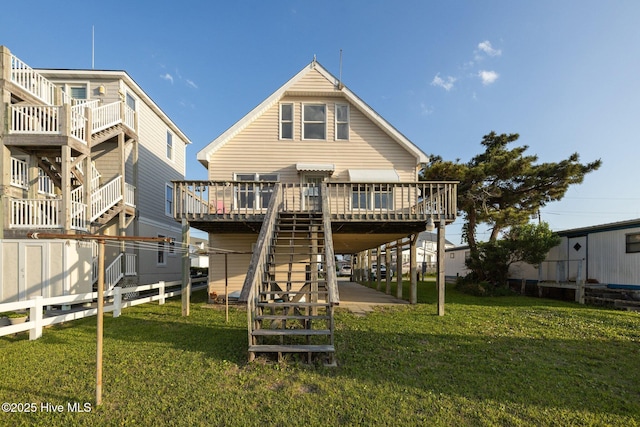 241 Moonlight Dr, Atlantic Beach, NC 28512 - back of house with stairway, a deck, and a lawn