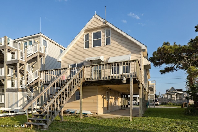 241 Moonlight Dr, Atlantic Beach, NC 28512 - rear view of property with a yard, a deck, and stairway