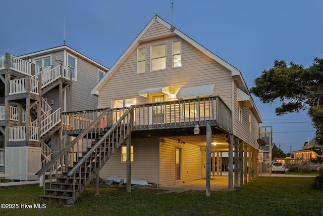 241 Moonlight Dr, Atlantic Beach, NC 28512 - back of house with a yard, a deck, and stairs