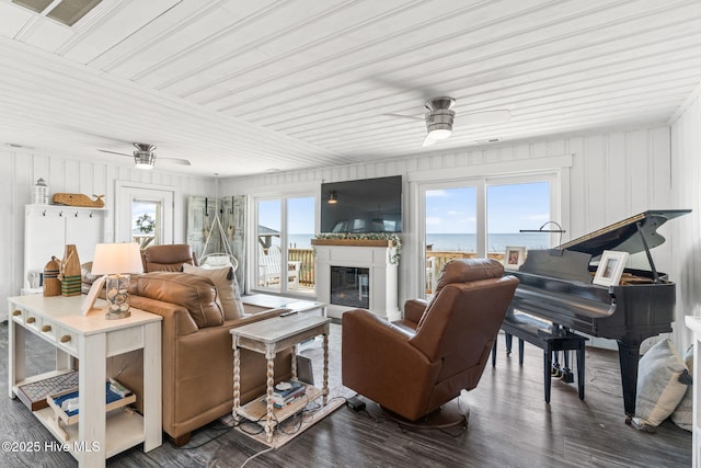 1001 W Beach Dr, Oak Island, NC 28465 - living room with a ceiling fan, wooden ceiling, a glass covered fireplace, and dark wood-type flooring