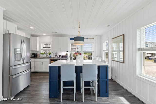 1001 W Beach Dr, Oak Island, NC 28465 - kitchen with appliances with stainless steel finishes, dark wood-style floors, plenty of natural light, wooden ceiling, and recessed lighting