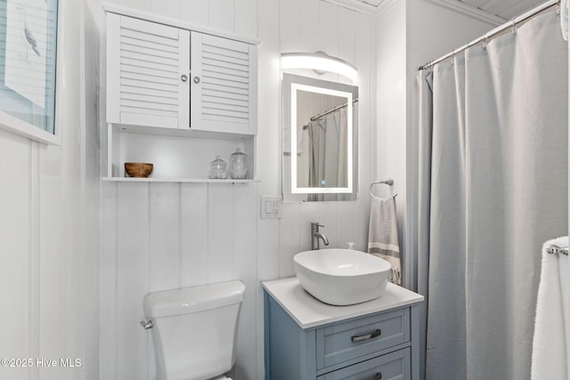 1001 W Beach Dr, Oak Island, NC 28465 - full bathroom featuring vanity, toilet, and ornamental molding