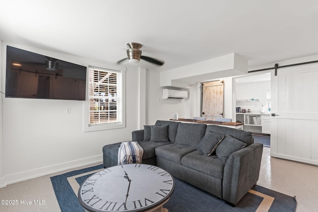 1001 W Beach Dr, Oak Island, NC 28465 - living area with a wall unit AC, a ceiling fan, baseboards, and a barn door