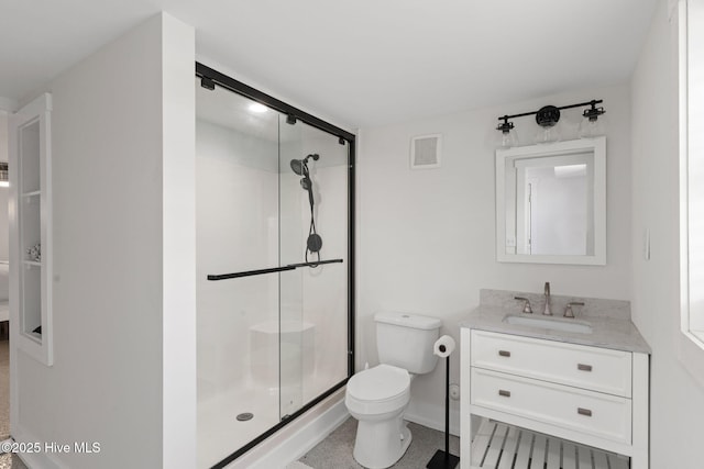 1001 W Beach Dr, Oak Island, NC 28465 - bathroom featuring a stall shower, toilet, vanity, and baseboards