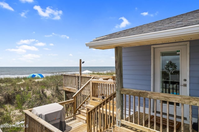 1001 W Beach Dr, Oak Island, NC 28465 - wooden terrace featuring view of water and beach and stairway