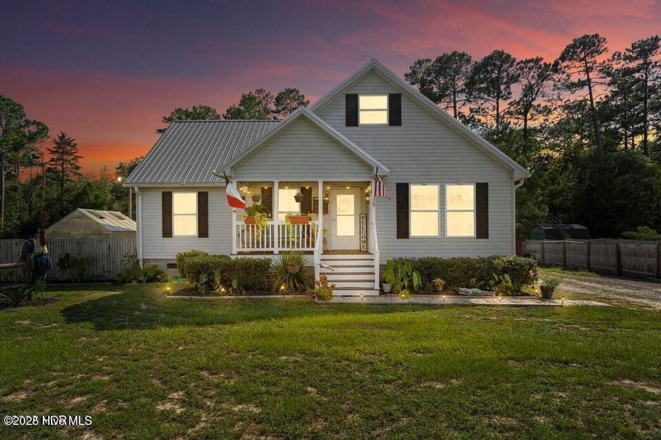 710 Ridgecrest Ln, Rocky Point, NC 28457 - view of front of home with a porch and metal roof