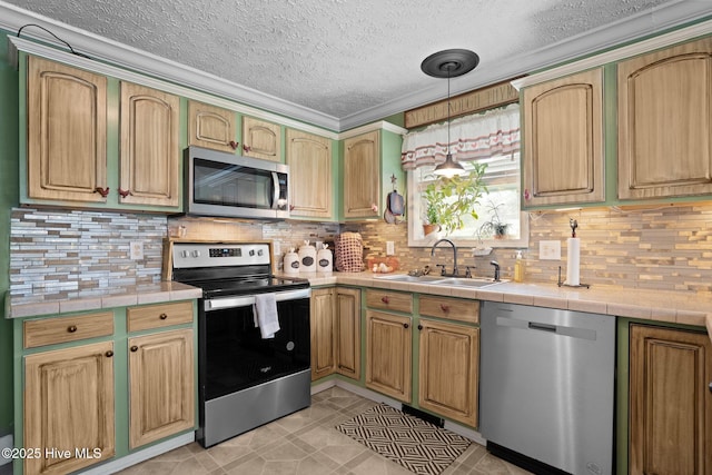 710 Ridgecrest Ln, Rocky Point, NC 28457 - kitchen with appliances with stainless steel finishes, a sink, tile countertops, a textured ceiling, and decorative backsplash