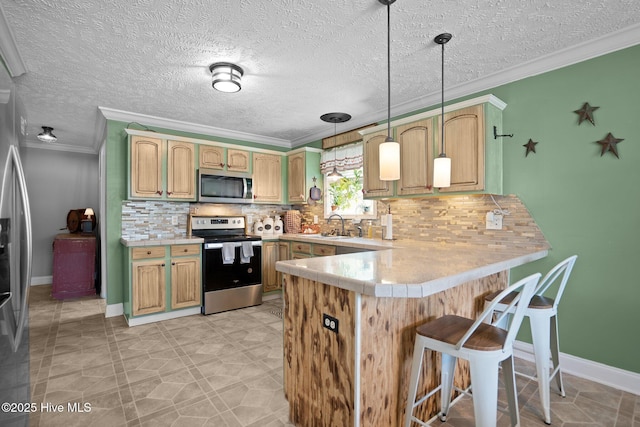 710 Ridgecrest Ln, Rocky Point, NC 28457 - kitchen with stainless steel appliances, a peninsula, light countertops, ornamental molding, and a breakfast bar area
