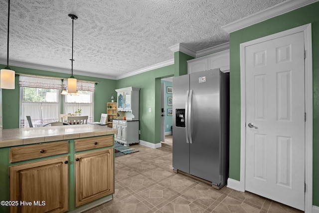 710 Ridgecrest Ln, Rocky Point, NC 28457 - kitchen featuring stainless steel fridge, a textured ceiling, pendant lighting, crown molding, and baseboards