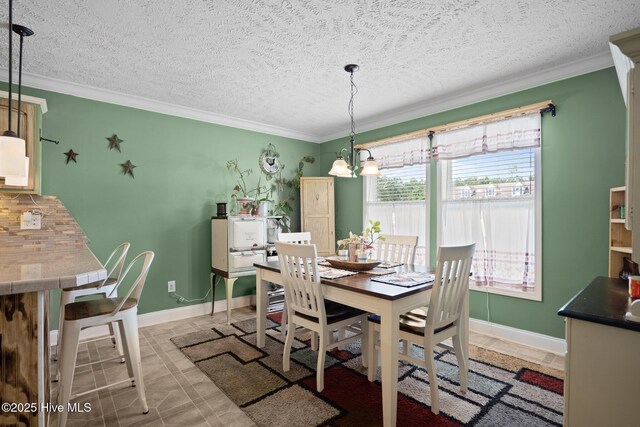 710 Ridgecrest Ln, Rocky Point, NC 28457 - dining room featuring crown molding, a textured ceiling, baseboards, and a chandelier