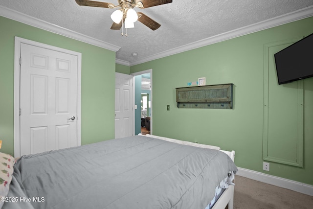 710 Ridgecrest Ln, Rocky Point, NC 28457 - carpeted bedroom featuring a textured ceiling, ornamental molding, baseboards, and ceiling fan