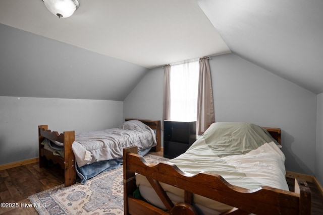 710 Ridgecrest Ln, Rocky Point, NC 28457 - bedroom featuring wood finished floors, vaulted ceiling, and baseboards