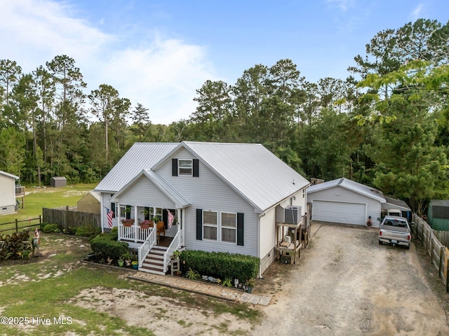 710 Ridgecrest Ln, Rocky Point, NC 28457 - view of front of home featuring covered porch, a detached garage, an outdoor structure, and metal roof
