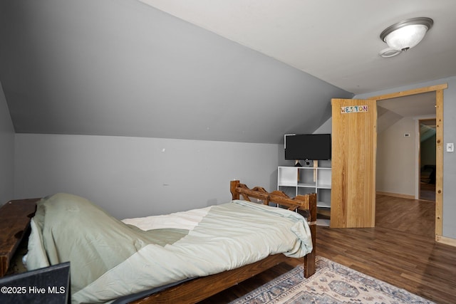 710 Ridgecrest Ln, Rocky Point, NC 28457 - bedroom featuring wood finished floors and vaulted ceiling