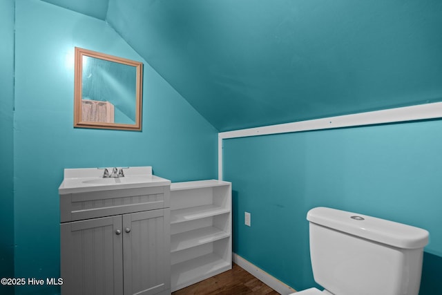 710 Ridgecrest Ln, Rocky Point, NC 28457 - bathroom with vaulted ceiling, vanity, and wood finished floors