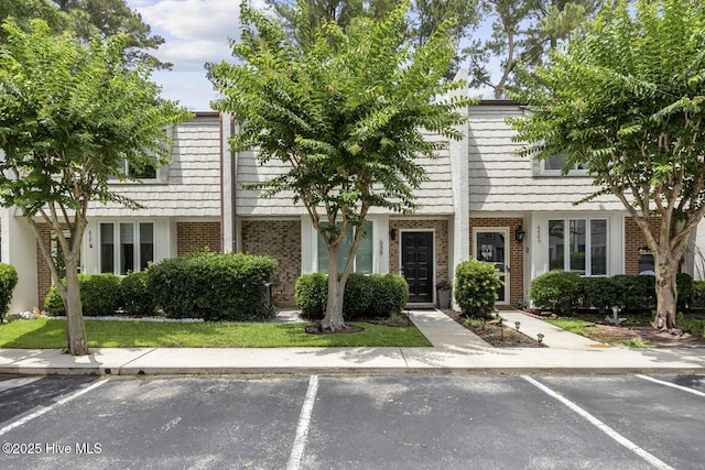 648 Cobblestone Dr, Wilmington, NC 28405 - townhome / multi-family property with brick siding, uncovered parking, and mansard roof