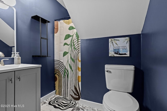 648 Cobblestone Dr, Wilmington, NC 28405 - bathroom with vanity, toilet, vaulted ceiling, baseboards, and curtained shower