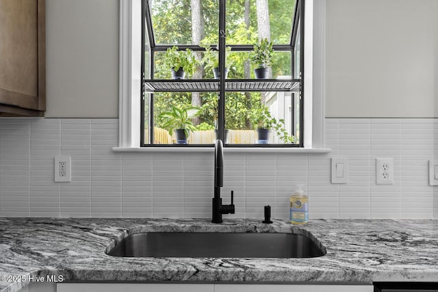 648 Cobblestone Dr, Wilmington, NC 28405 - kitchen view of a sink, tasteful backsplash, and light stone counters