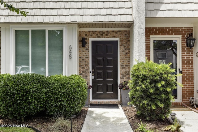 648 Cobblestone Dr, Wilmington, NC 28405 - view of exterior entry with brick siding and mansard roof