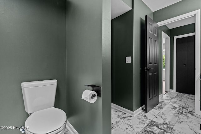 648 Cobblestone Dr, Wilmington, NC 28405 - bathroom with marble look tiles, baseboards, and toilet