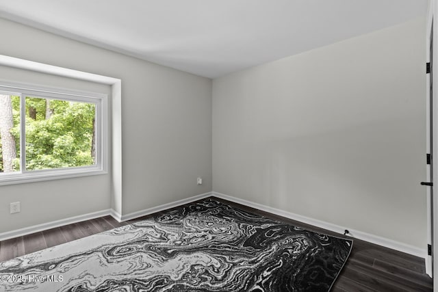 648 Cobblestone Dr, Wilmington, NC 28405 - spare room with dark wood-style flooring and baseboards