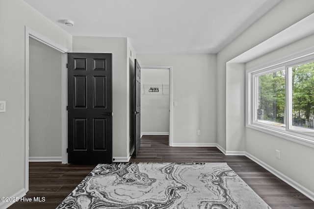 648 Cobblestone Dr, Wilmington, NC 28405 - unfurnished bedroom featuring dark wood-type flooring and baseboards