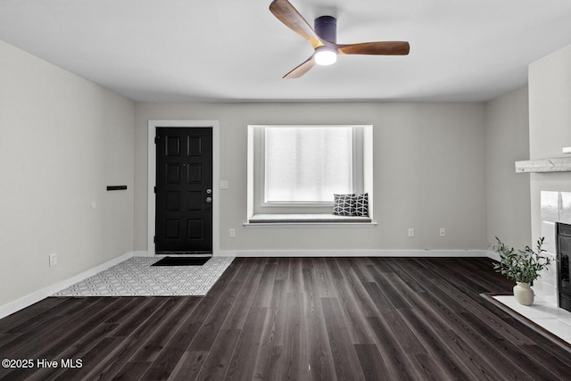 648 Cobblestone Dr, Wilmington, NC 28405 - entrance foyer with wood finished floors, baseboards, ceiling fan, and a fireplace with flush hearth