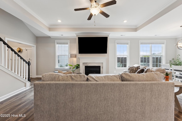 438 Sugar Cove Run, Wilmington, NC 28411 - living room with a tray ceiling, a fireplace, stairway, dark wood-style floors, and ceiling fan