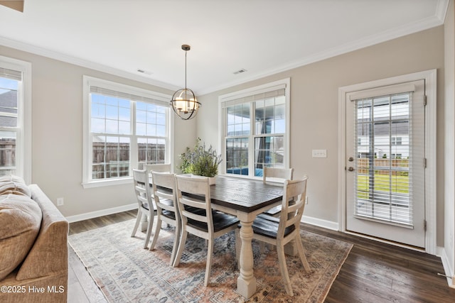 438 Sugar Cove Run, Wilmington, NC 28411 - dining area featuring crown molding, a chandelier, dark wood-style floors, and baseboards