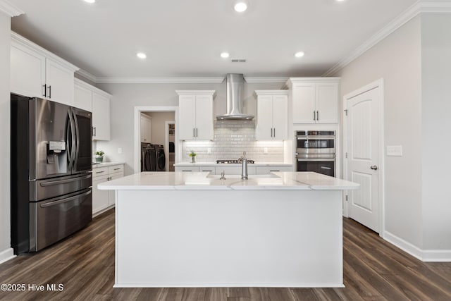 438 Sugar Cove Run, Wilmington, NC 28411 - kitchen featuring appliances with stainless steel finishes, wall chimney exhaust hood, independent washer and dryer, a sink, and a center island with sink
