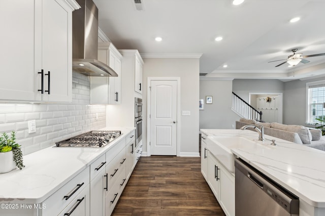 438 Sugar Cove Run, Wilmington, NC 28411 - kitchen with wall chimney range hood, appliances with stainless steel finishes, open floor plan, a sink, and decorative backsplash