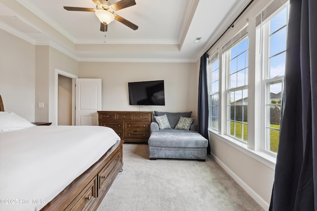 438 Sugar Cove Run, Wilmington, NC 28411 - bedroom with multiple windows, a tray ceiling, light carpet, ornamental molding, and a ceiling fan