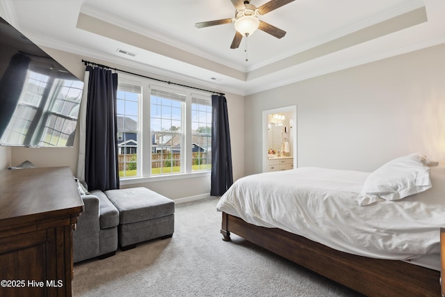 438 Sugar Cove Run, Wilmington, NC 28411 - carpeted bedroom featuring a tray ceiling, ornamental molding, baseboards, connected bathroom, and a ceiling fan