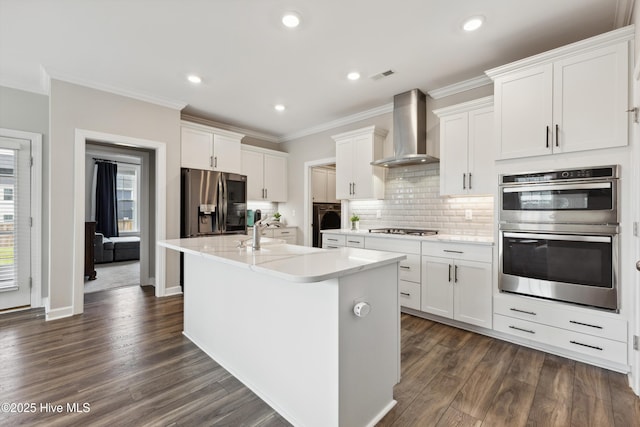 438 Sugar Cove Run, Wilmington, NC 28411 - kitchen featuring appliances with stainless steel finishes, wall chimney range hood, a sink, dark wood-type flooring, and crown molding