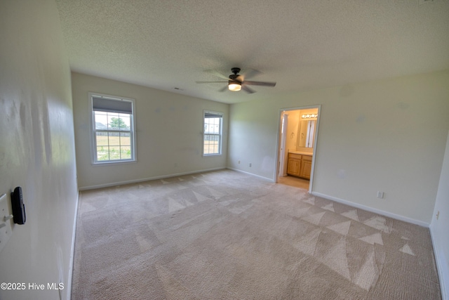 7308 Peppercorn Ct, Wilmington, NC 28411 - empty room with light carpet, ceiling fan, a textured ceiling, and baseboards