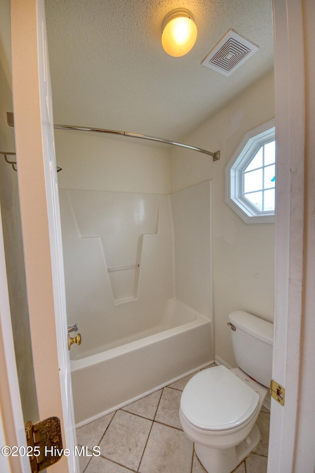 7308 Peppercorn Ct, Wilmington, NC 28411 - full bath featuring toilet, shower / bath combination, tile patterned floors, and a textured ceiling