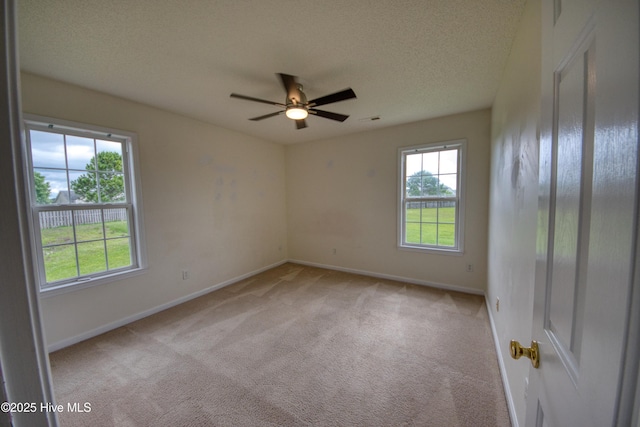7308 Peppercorn Ct, Wilmington, NC 28411 - unfurnished room featuring light carpet, ceiling fan, baseboards, and a textured ceiling