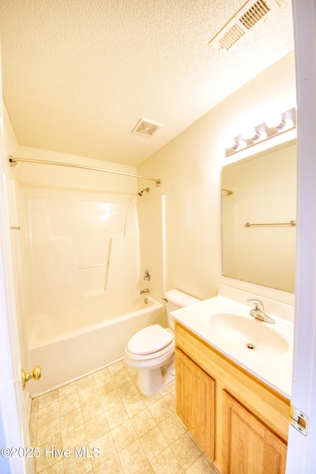7308 Peppercorn Ct, Wilmington, NC 28411 - full bath featuring vanity, toilet, washtub / shower combination, and a textured ceiling