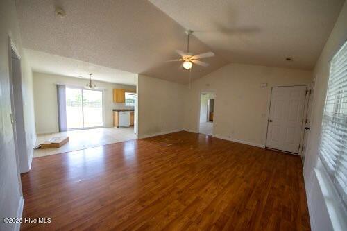 7308 Peppercorn Ct, Wilmington, NC 28411 - unfurnished living room featuring wood finished floors, a ceiling fan, and vaulted ceiling