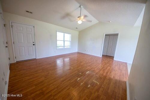 7308 Peppercorn Ct, Wilmington, NC 28411 - empty room featuring ceiling fan, vaulted ceiling, and wood finished floors