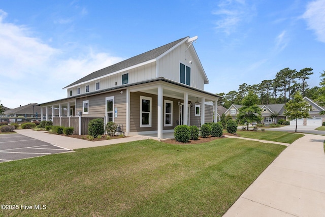 2169 Whiskey Branch Dr, Wilmington, NC 28409 - view of front of home featuring a front yard, a porch, uncovered parking, and board and batten siding