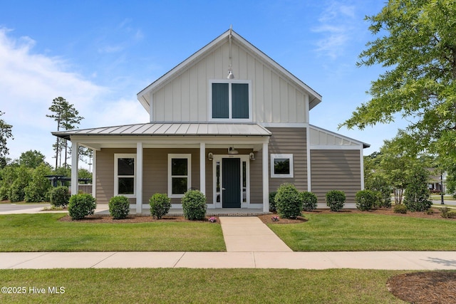 2169 Whiskey Branch Dr, Wilmington, NC 28409 - view of front of property with a standing seam roof, covered porch, board and batten siding, and a front yard