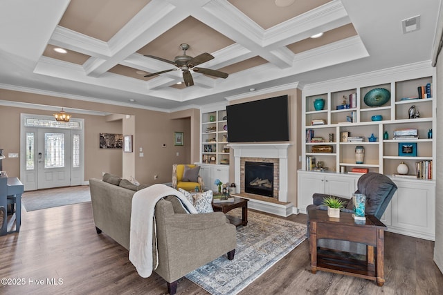 2169 Whiskey Branch Dr, Wilmington, NC 28409 - living area featuring ornamental molding, wood finished floors, beamed ceiling, ceiling fan, and a fireplace with raised hearth