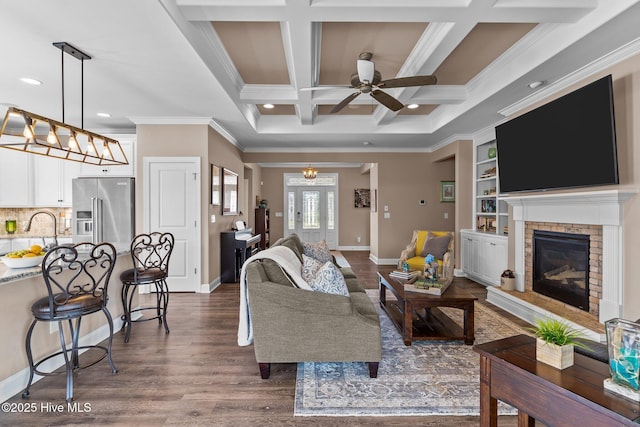 2169 Whiskey Branch Dr, Wilmington, NC 28409 - living area featuring ceiling fan, a fireplace, dark wood-style flooring, ornamental molding, and beamed ceiling