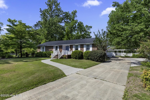 1205 Logan Ct, Jacksonville, NC 28540 - ranch-style home featuring brick siding, a front yard, and driveway