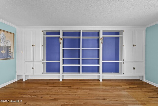 1205 Logan Ct, Jacksonville, NC 28540 - unfurnished room featuring wood finished floors, ornamental molding, a textured ceiling, and baseboards